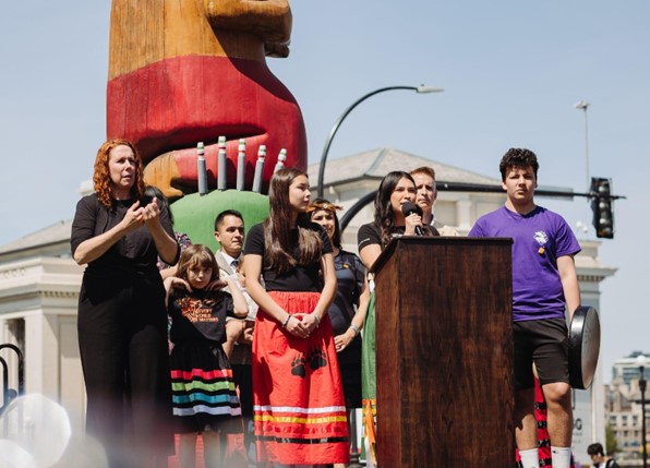 Sage Lacerte, sister of co-founder Raven Lacerte, speaks at the podium on Moose Hide Campaign Day 2023 in Victoria, B.C. to raise awareness for gender-based violence and advocate for change. Credit: Tegan McMartin.