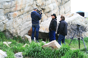 camera crew at rock site