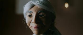 Claymation character is an old woman with grey hair pulled back into a bun behind her head.