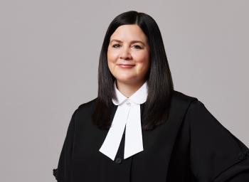 This is a photo of a woman in a black Supreme Court of Canada robe and white collar.