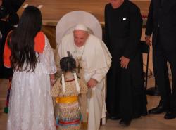 Pope Francis accepts a gift from mother and daughter. 