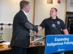Justice Minister Tyler Shandro shakes hands with Siksika Nation Chief Ouray Crowfoot 