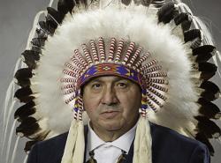 Chief Roy Fox of the Blood Tribe wears a feather headdress.