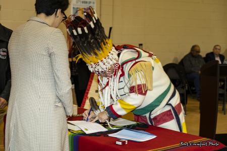Chief Ouray Crowfoot signs official documents